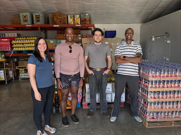 Smiling people standing in front of shelves of food