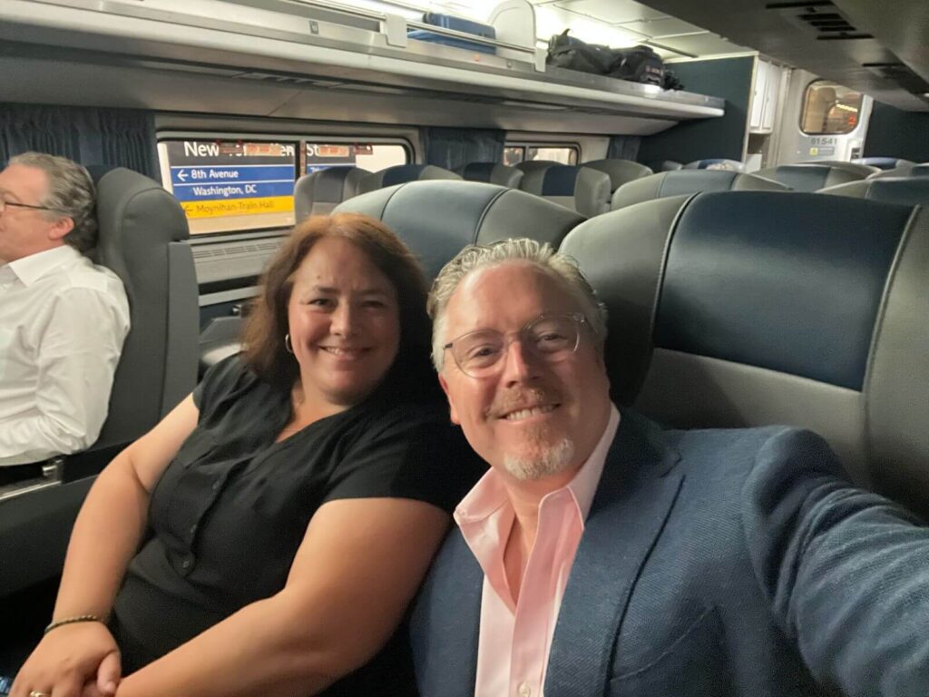 Smiling man and woman on a plane