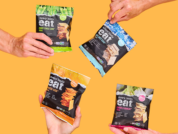 Hands holding packages of Snack Thins in multiple flavors