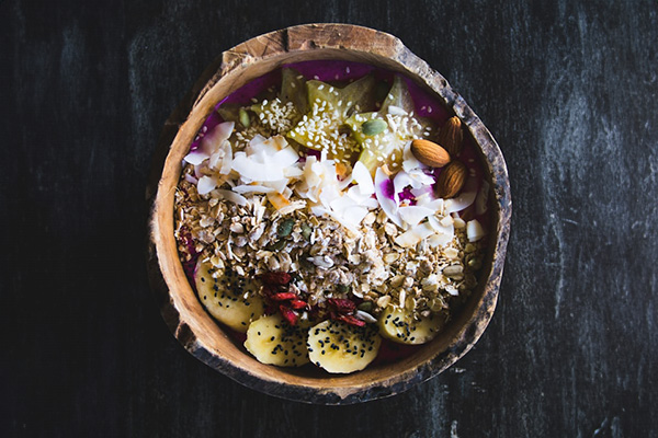Smoothie bowl with a variety of fruits and seeds, including star fruit