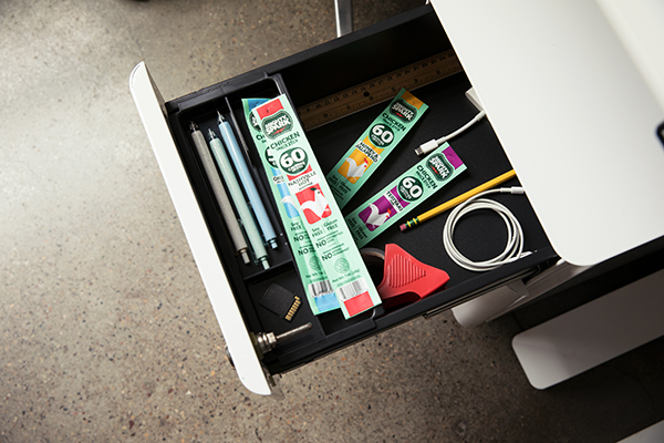 Mighty Spark chicken snack sticks in a desk drawer with other office supplies