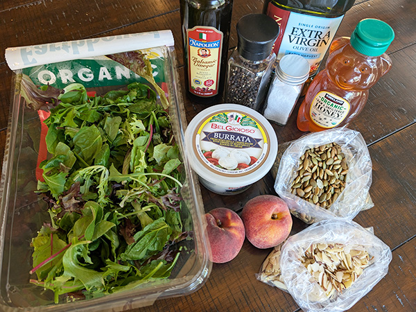 grilled peach and burrata salad ingredients gathered on a table