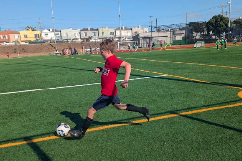 Boy kicking soccer ball