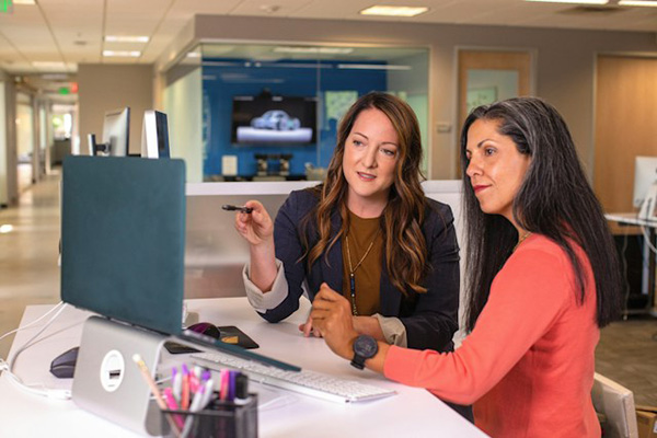 Two women working on computer